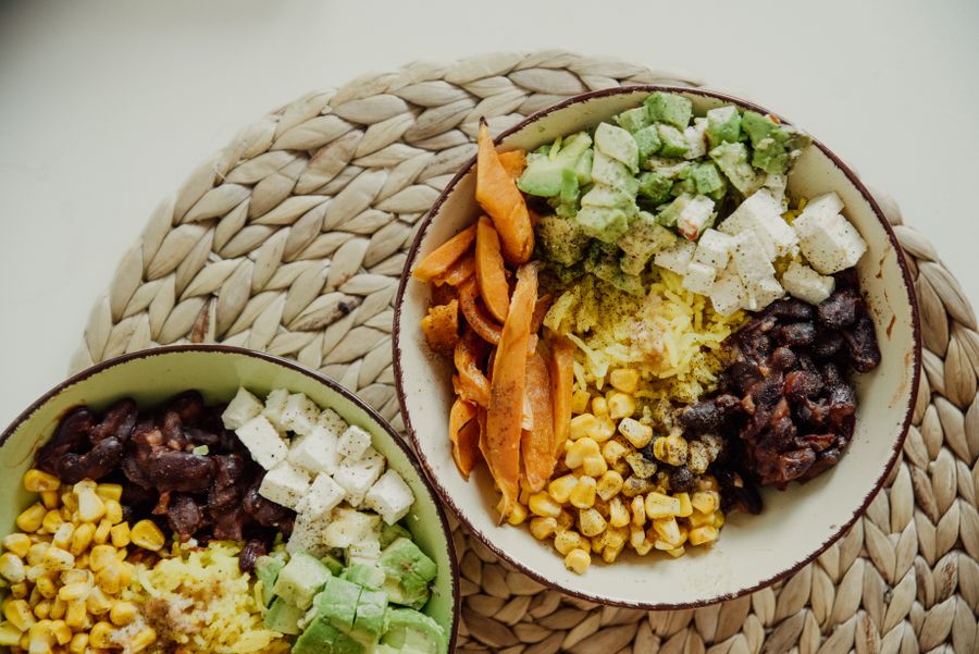 Colourful healthy bowls with vegetables, beans and grains