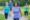 Woman in purple shirt smiling as she is walking for weight loss in front of three other people.